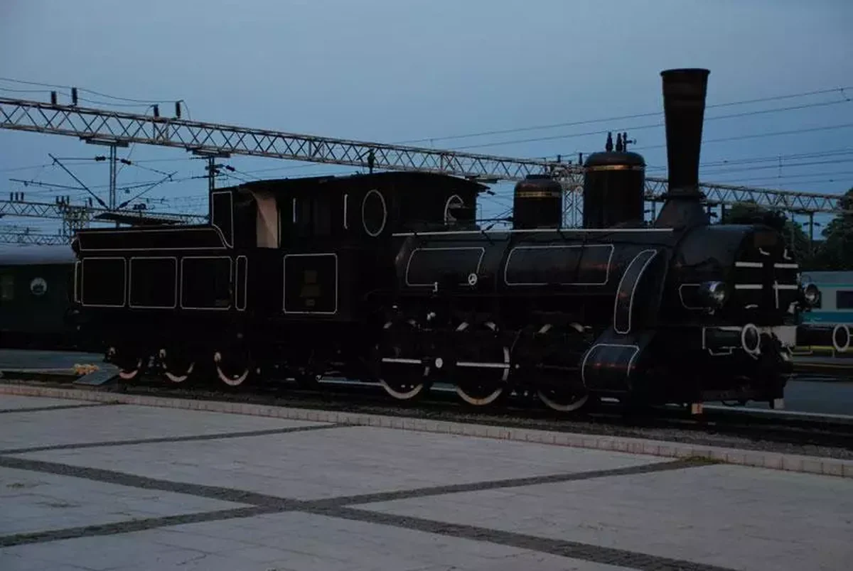 Historic steam locomotive at a railway station