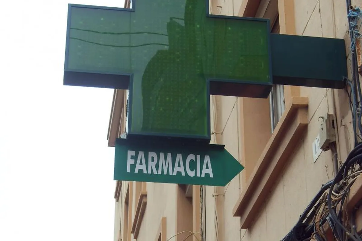Green pharmacy sign on a building